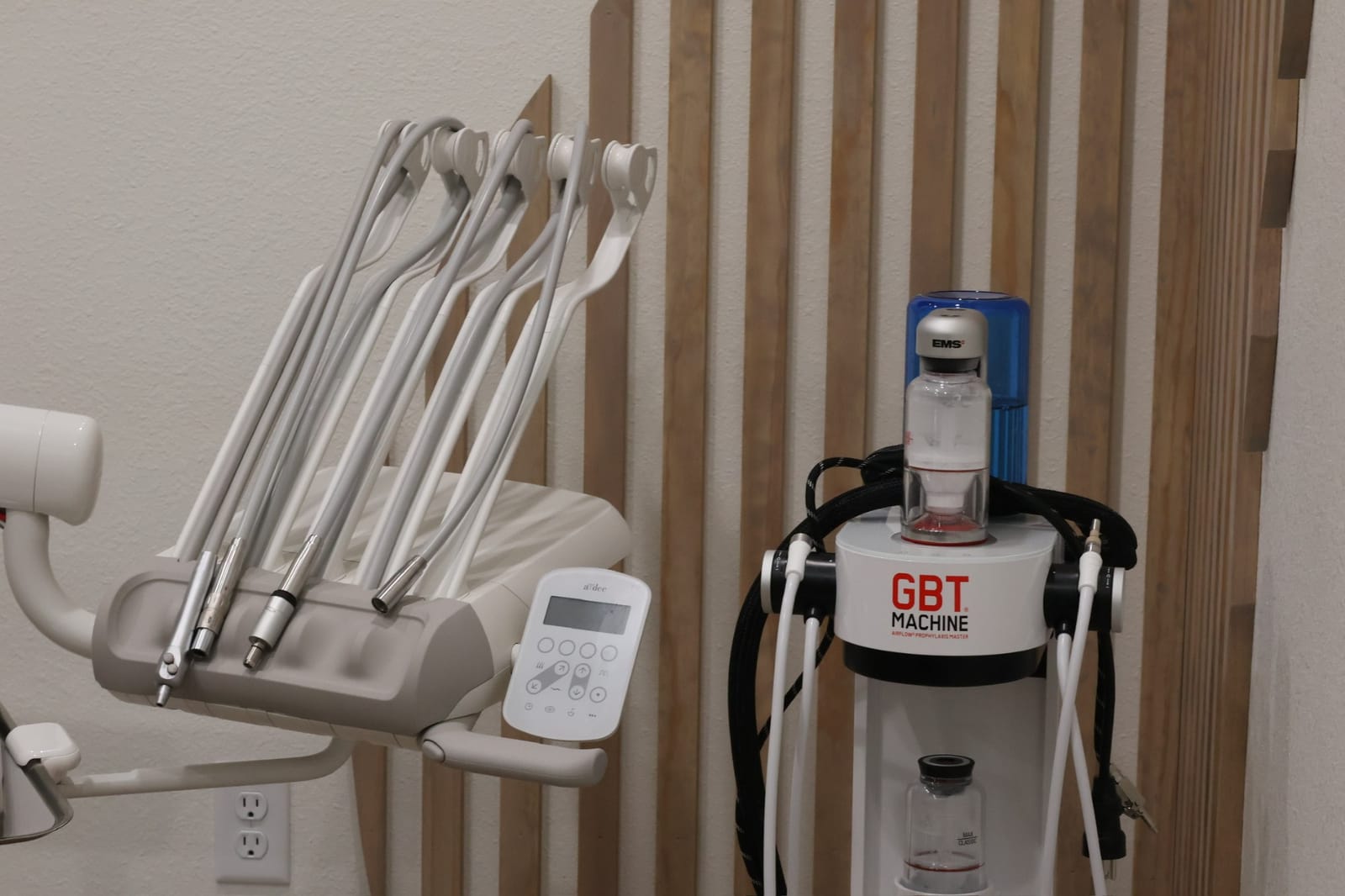 The EMS Guided Biofilm Therapy unit beside a dental chair at Omni Dental Studio